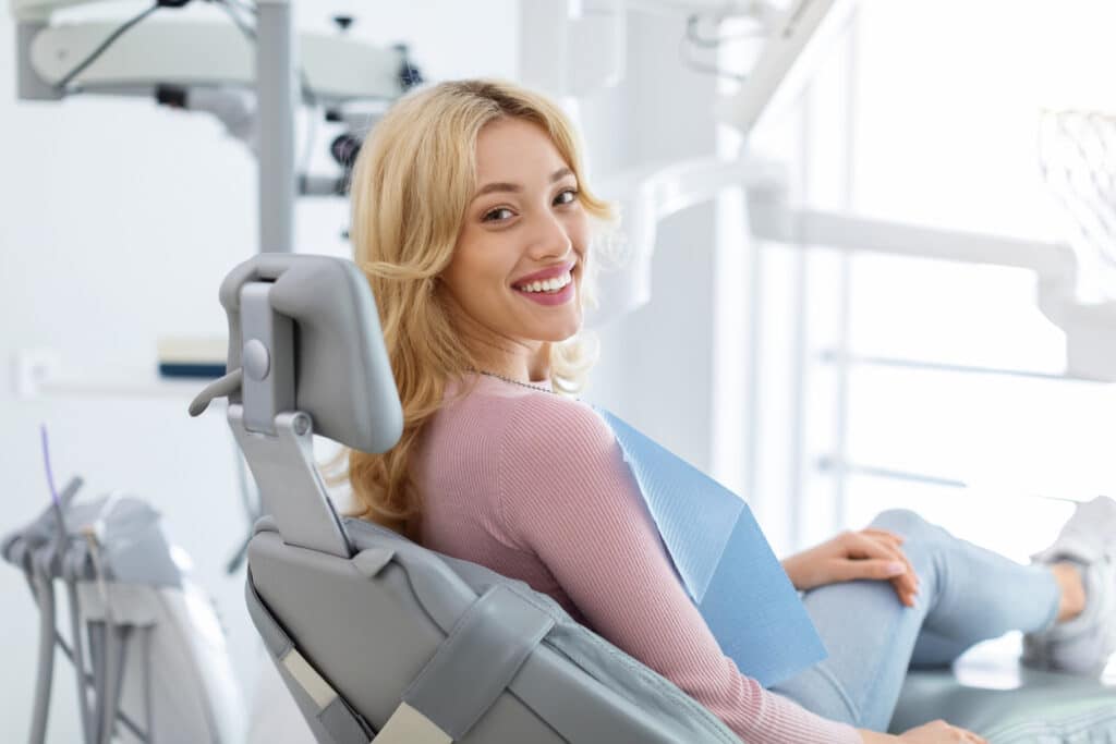 a female orthodontic patient sitting on the dental chair about to receive treatment