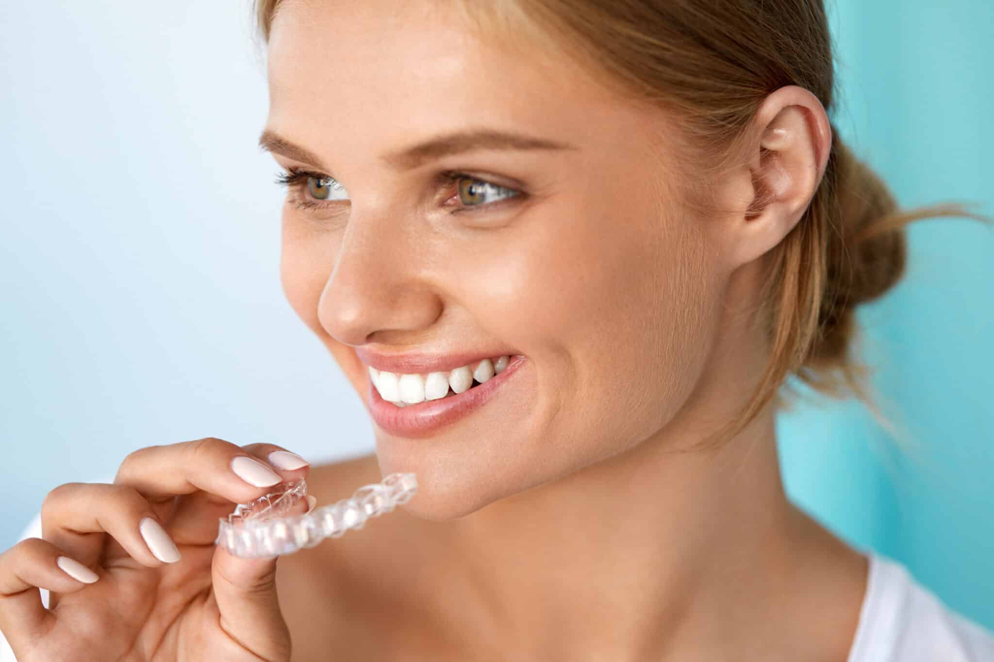 Smiling Woman With Beautiful Smile Using Teeth Whitening Tray