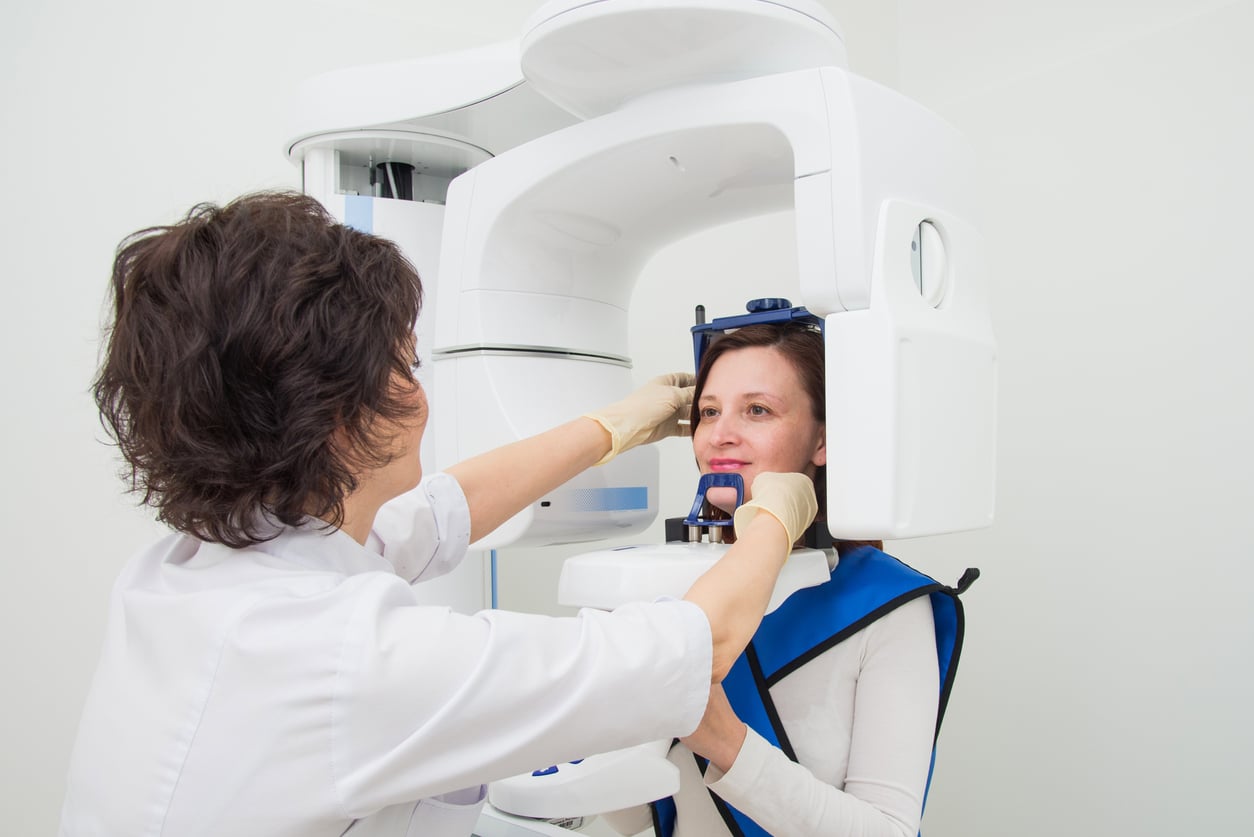 an orthodontic assistant giving an orthodontic patient a ct x-ray 